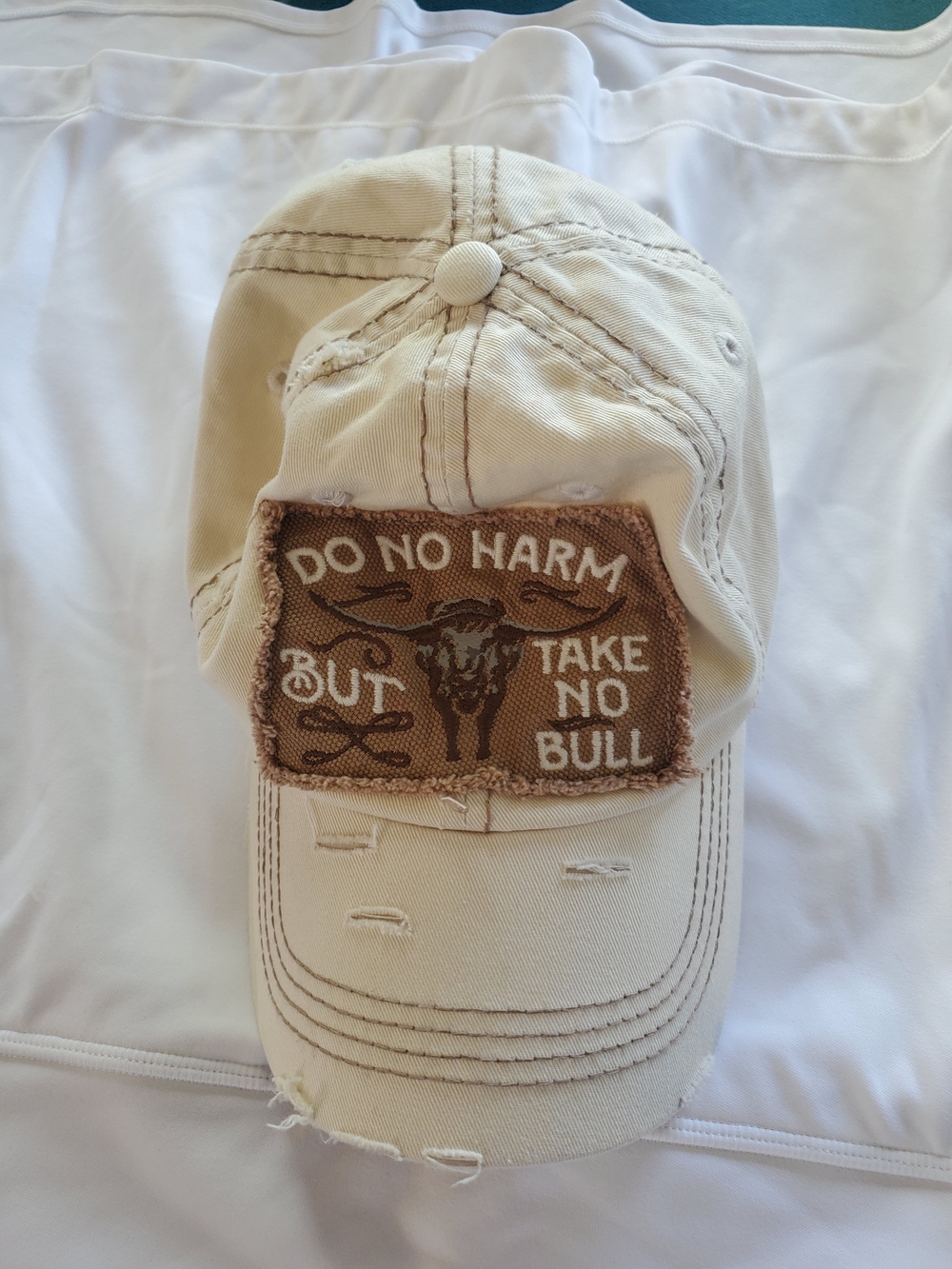 Tan Distressed Baseball Cap with 'Do No Harm' Patch